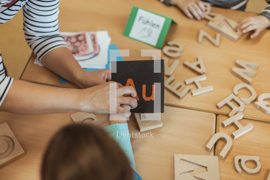 children playing with alphabet blocks 