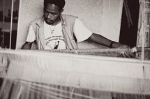man weaving on a loam