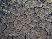  A dry river bed affected by drought and lack of rain shows the cracked dry earth that brings drought, famine and starvation to many throughout history.