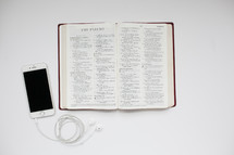 open Bible and iPhone with earbuds 
