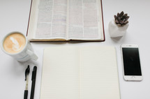 a desk with items for a Bible study 