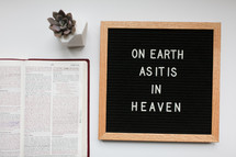 On earth as it is in Heaven sign and open Bible 