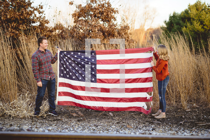 couple holding an American flag 