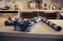 wrapped Christmas presents on a kitchen counter 