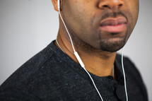 face of a man with earbuds