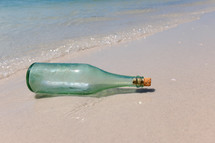 A message in a bottle on a beach.