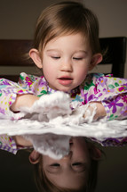 toddler girl playing with foam and shaving cream 