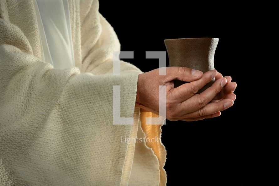 Jesus hands holding a cup 