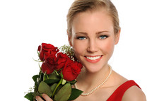 Smiling woman holding a bouquet of roses.