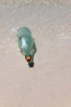Message in a bottle on a beach.