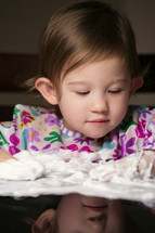 toddler girl playing with foam 