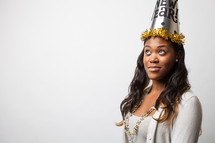 A woman wearing a New Year's Party hat. 
