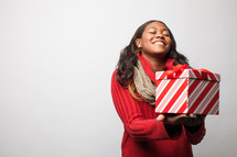 A woman holding a Christmas present. 