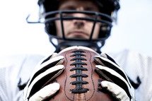 football player holding the football 