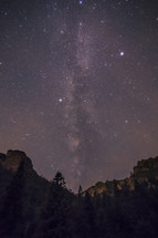 Moonight on mountains with stars above.