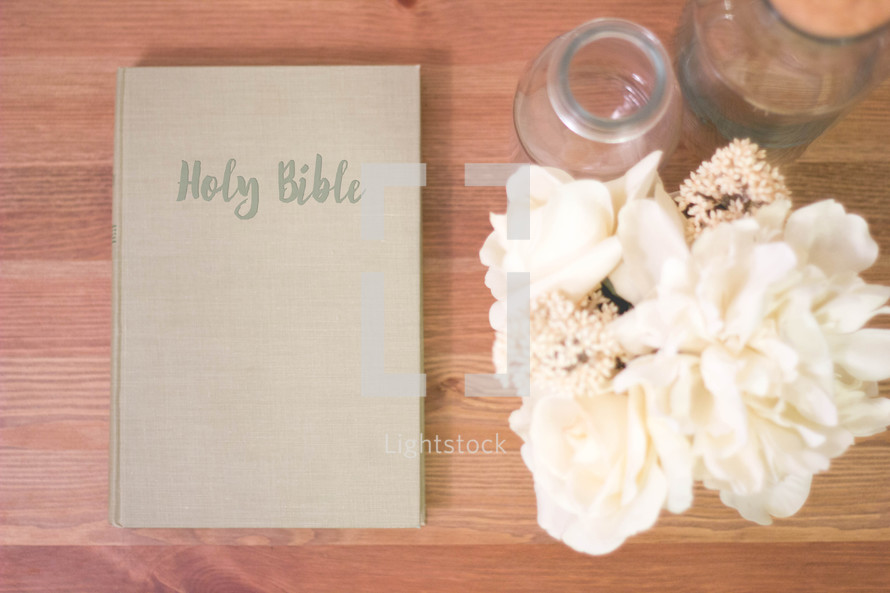 Holy Bible, flower, glass bottles, on a wood