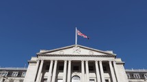Union Jack waving on top of the Bank of England in London