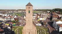 Church tower in Wijk aan Zee, coastal town in the Netherlands . Aerial dolly out