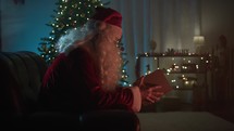 Santa Claus admiring a magic Christmas book