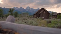 Old Wooden Chapel in the Mountains at Sunset