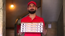 Smiling pizza delivery man with boxes