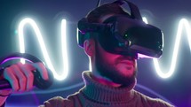 A bearded man playing a virtual reality game.