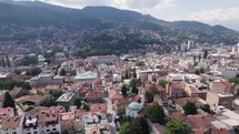 Capital city of Sarajevo in mountainous hilly terrain. Aerial trucking