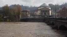TURIN, ITALY—River Po flood in city centre under a bridge.