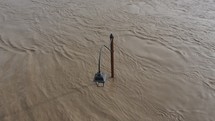 street lamp under river water during flood