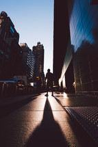 man walking on a city sidewalk 