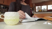 a woman sitting down to read a Bible 