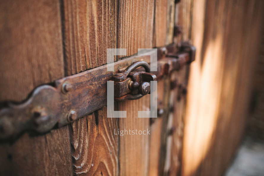 lock and hinge on a wooden door