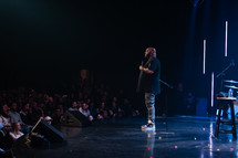 a man speaking on stage 