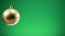 Gold ball decoration for Christmas with green background 