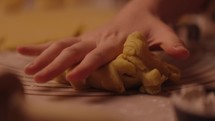 Young woman flouring and rolling homemade cookie dough for valentine's day