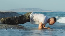 Soldier does plank on the beach