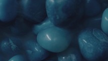 Blue gemstones rotating with a foggy atmosphere around them