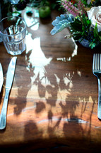 Shadows of flowers on table 