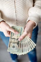 woman holding cash in hands 