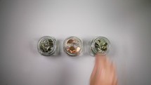 placing money in different jars 