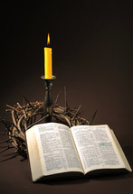 crown of thorns, candle, and opened Bible 