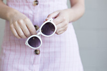 woman holding sunglasses 