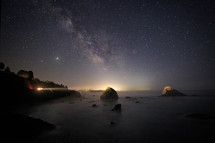 The Milky Way over a rocky Northern California beach.