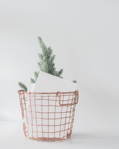 envelopes and small tree in a wire basket 