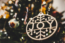 Joy ornament on a Christmas tree 