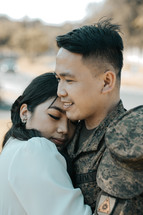 military couple hugging 