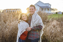 portrait of a couple wrapped in a blanket 