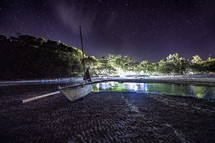 boat on a tropical shore at night 