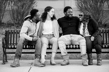 group of friends sitting on a bench 
