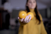 woman holding oranges 